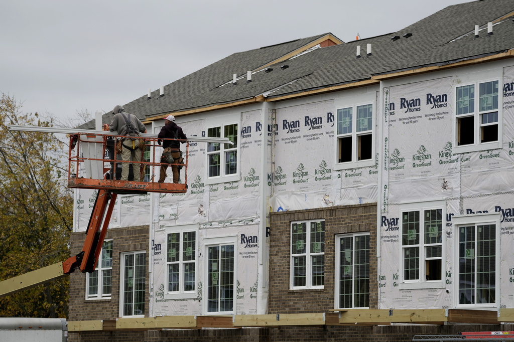   Construction workers work outside of residential building site in Wheeling, Ill., Wednesday, Nov. 6, 2024. 