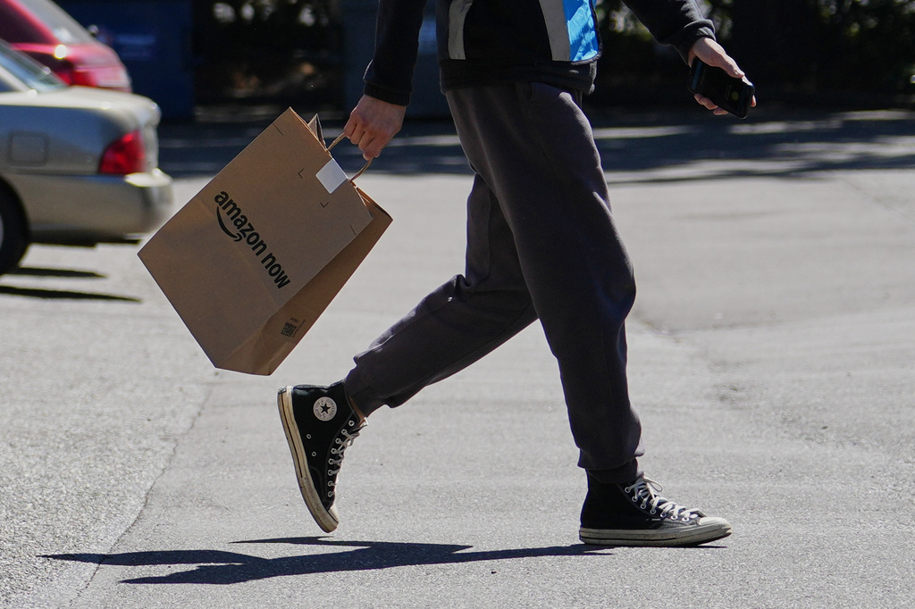 A driver picks up an order at an Amazon Now location, Monday, May 11, 2026, in Bellevue, Wash. 