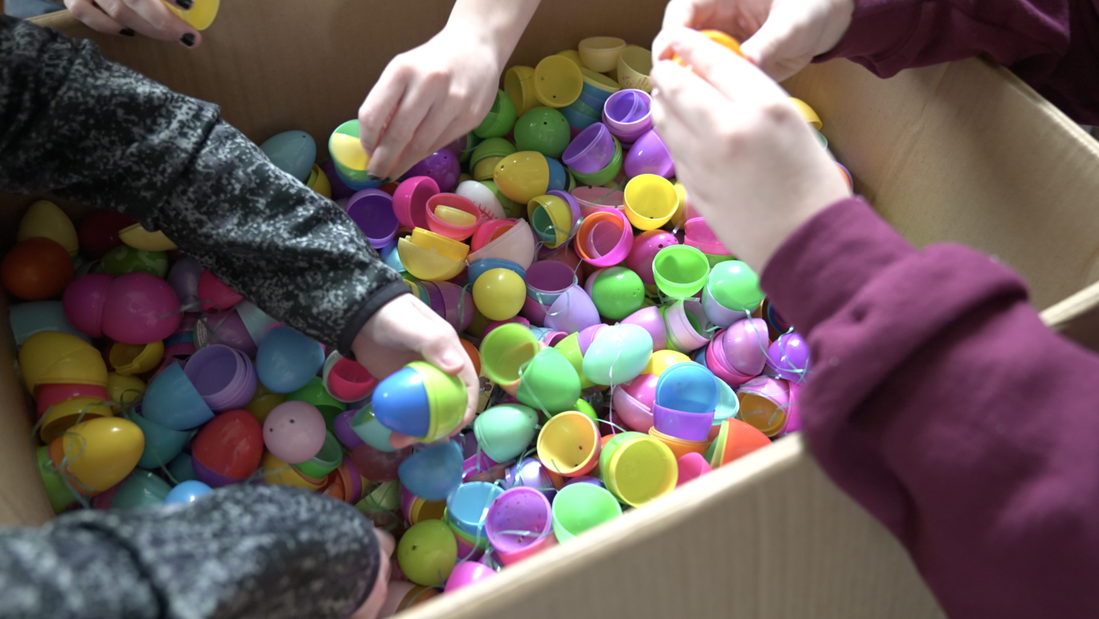 Students filling easter eggs with candy