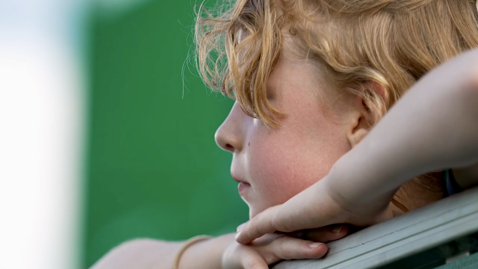 little girl watches game.jpg