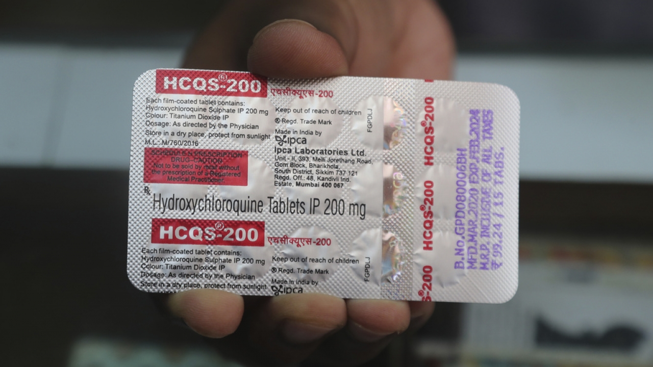 A chemist displays hydroxychloroquine tablets.