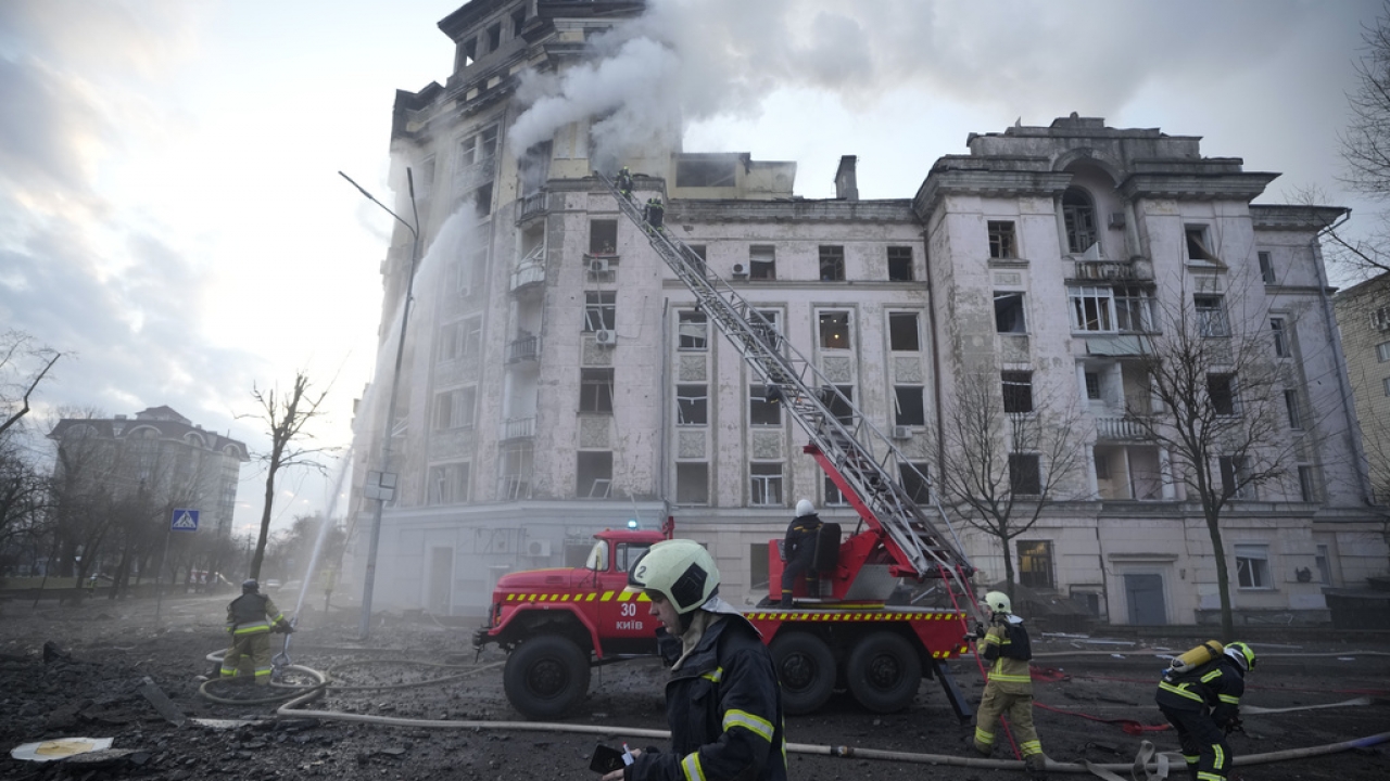 Firefighters work at the site of a Russian missile strike in Kyiv, Ukraine.
