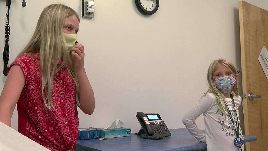11-year old Lydia Harpin and 7-year old Hannah Harpin help translate for patients their dad Scott is vaccinating at CU's Family Health Services clinic in Sheridan, Colorado..png