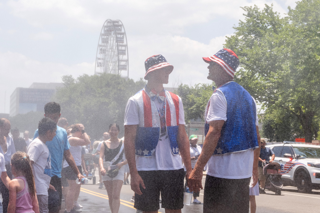 Attendees cool off in mist at the Great American State Fair on the National Mall, Friday, July 3, 2026, in Washington. 
