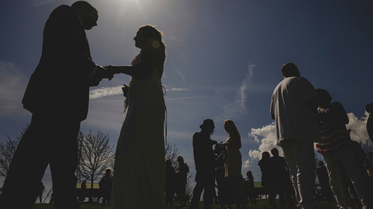 File photo of couples exchanging vows under a solar eclipse.