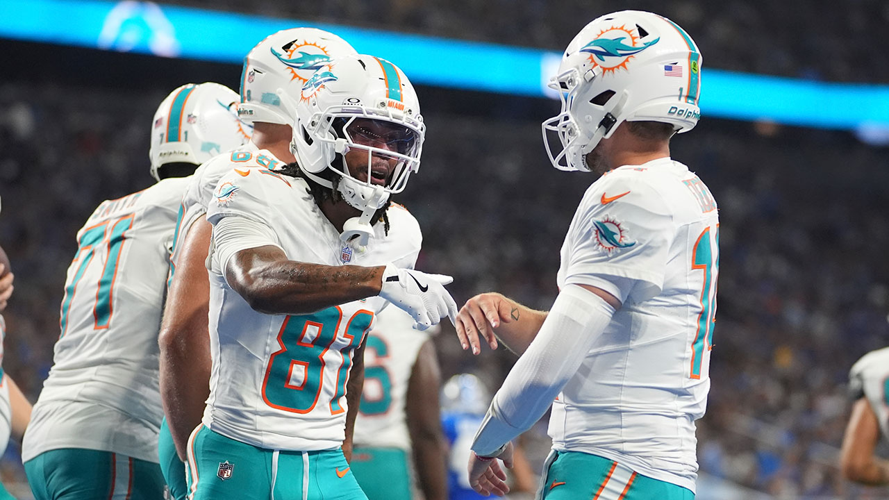 Miami Dolphins quarterback Quinn Ewers (14) celebrates his touchdown pass to wide receiver Theo Wease Jr. (81) during the second half of an NFL preseason football game against the Detroit Lions Saturday, Aug. 16, 2025, in Detroit. (AP Photo/Ryan Sun)