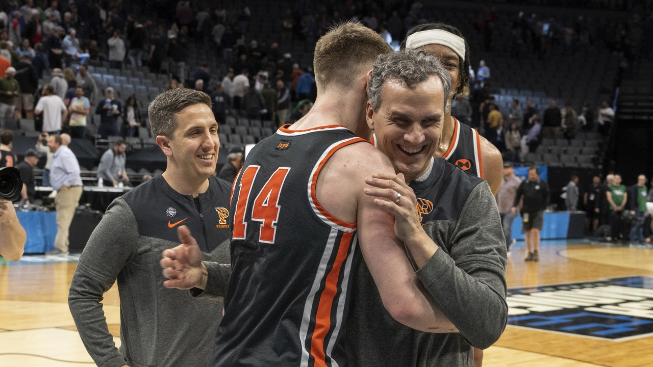 Princeton head coach Mitch Henderson embraces guard Matt Allocco.
