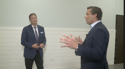 WPTV Anchor Mike Trim listens to Dean Butters of Calvary Church about Calvary's proposed K-12 school